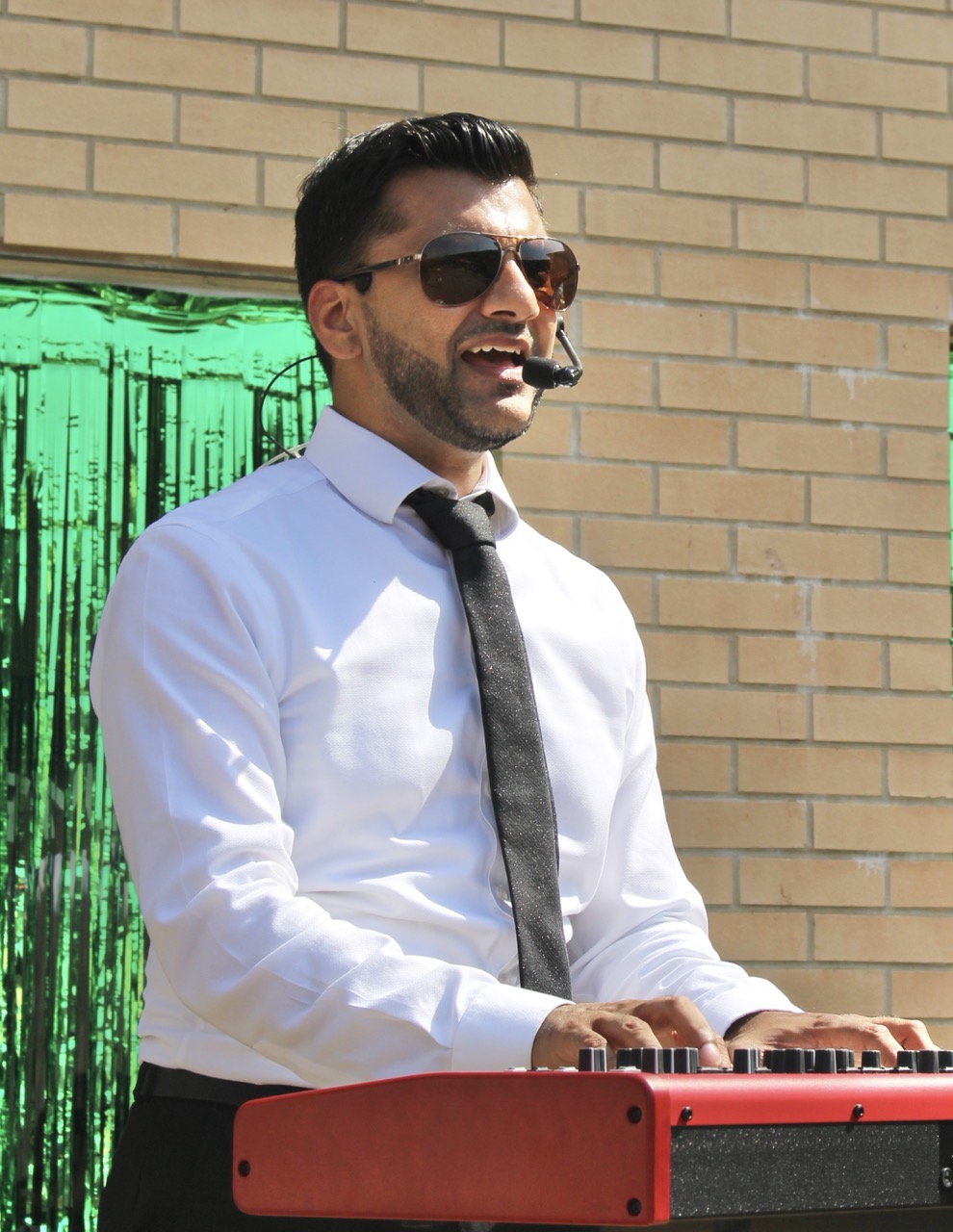 Ken performing at an outdoor summer party and school college festival